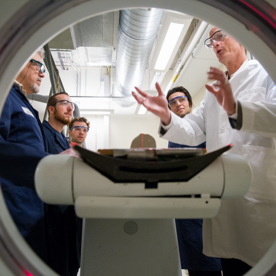 A group of researchers discuss the use of MRI machines.