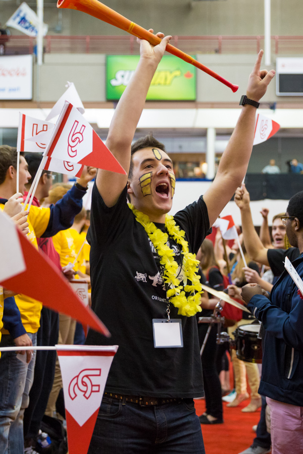 A male student cheers at a pep rally.