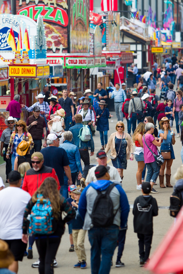 Crowds of people visit the Calgary Stampede.